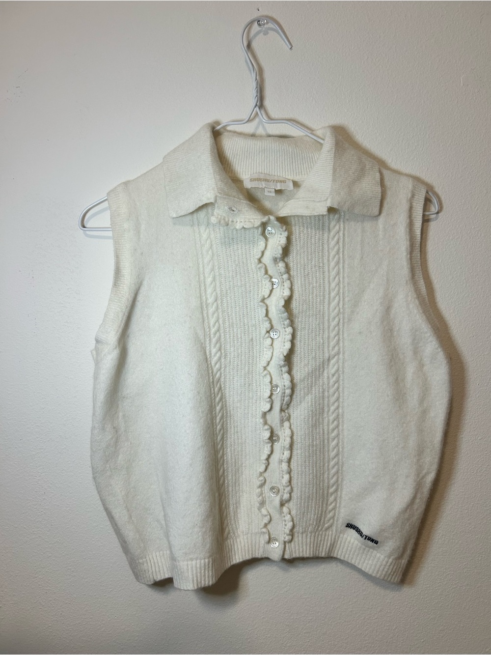 Sleeveless Collared Knit Cardigan in Cream with Ruffle Button Front